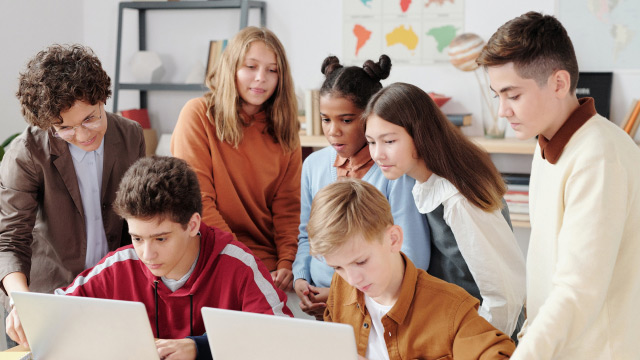 Teacher watching their students working with computers