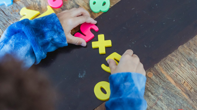 Child learning maths with numbers toys